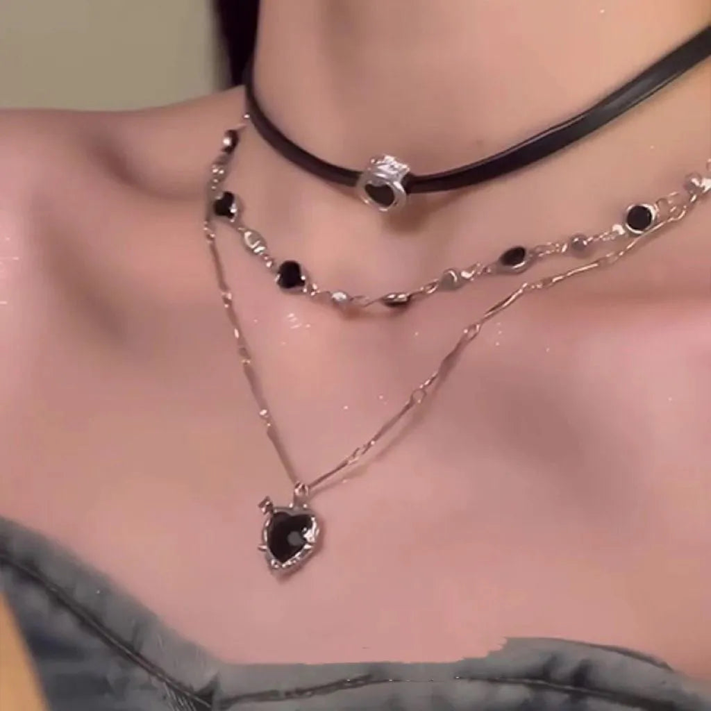Women's creative multi-layer twin necklace set with alloy heart pendant, artificial crystal, and leather on an adjustable chain.