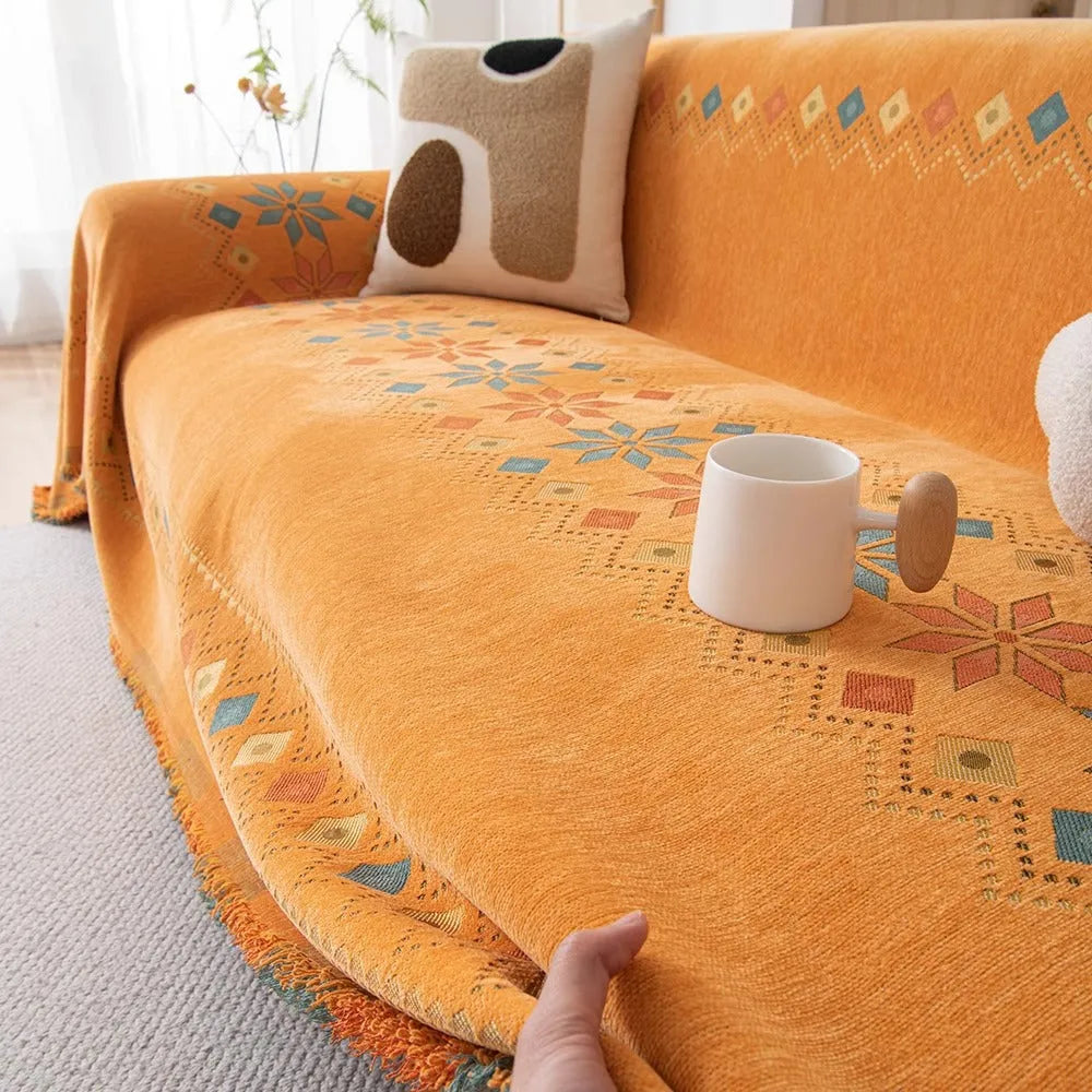 Universal chenille sofa cover in beige with Nordic west blanket pattern on a modern sofa