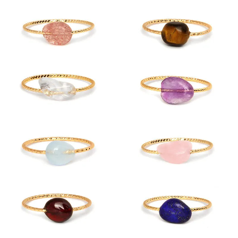 Women's geometric ring made from colourful agate stone on a neutral background.