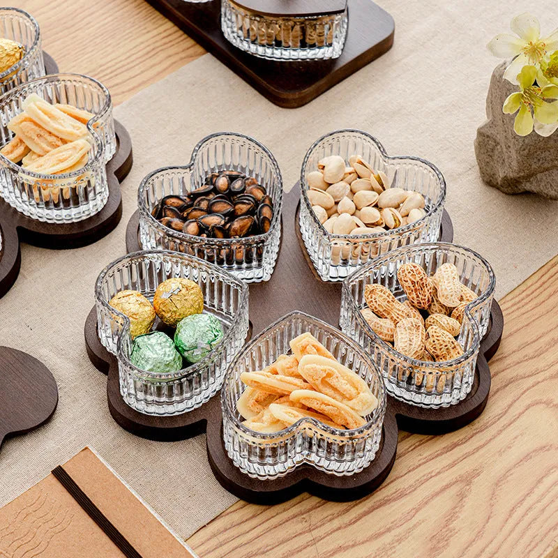 Glass fruit and snacks serving platter with multiple compartments and transparent heart-shaped lids in a retro style.