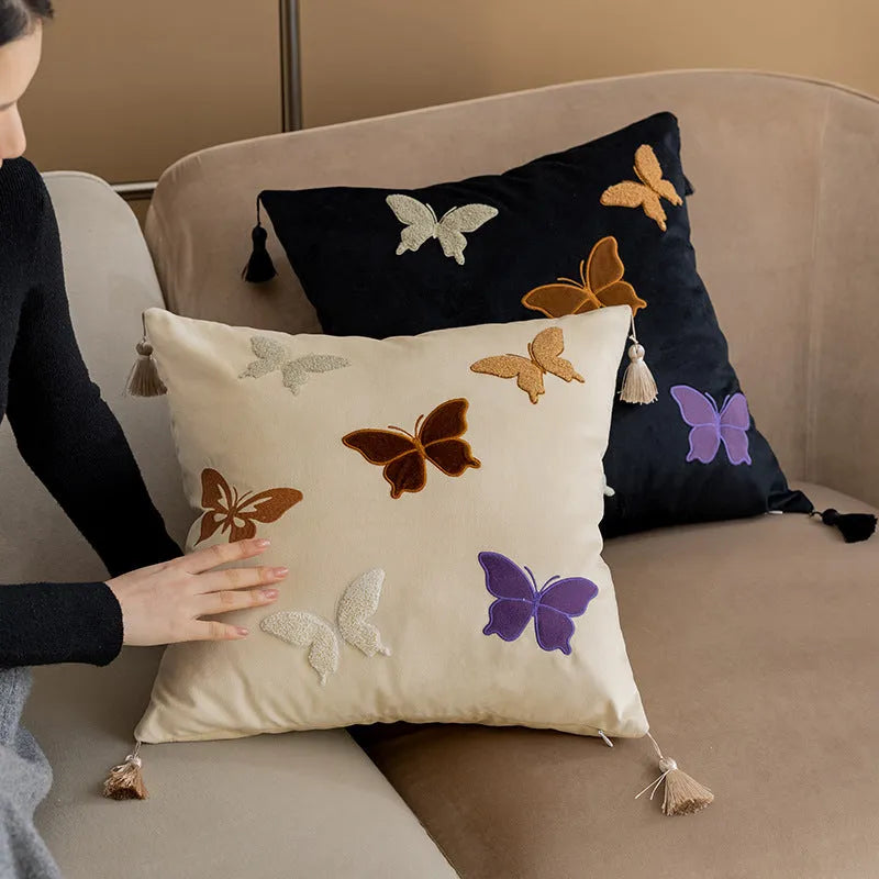 Square beige couch pillow with embroidered Chinese-style butterfly design.