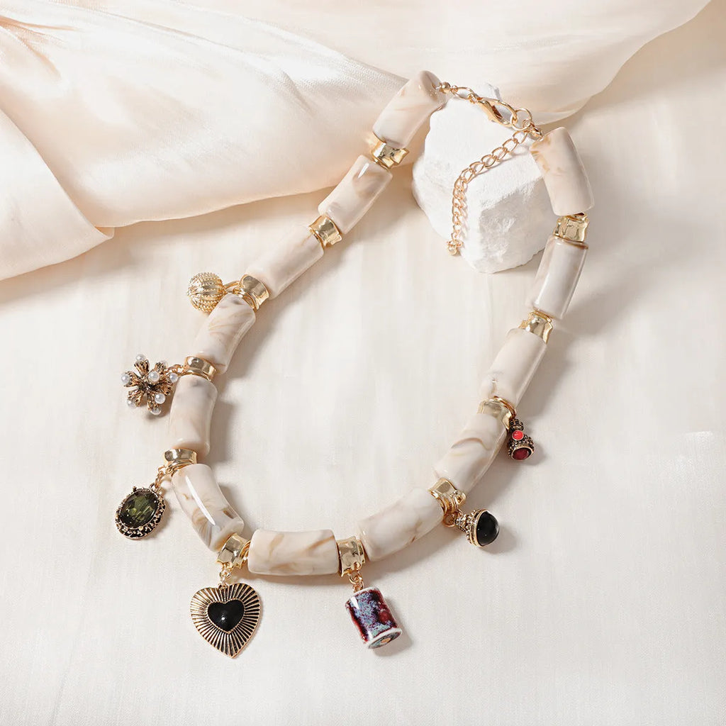 Gold-tone heart-shaped resin bamboo pendant necklace with electroplated chain