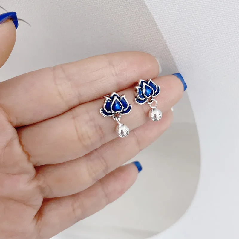 Blue lotus and seedpod earrings with dangling tassels on silver alloy posts.