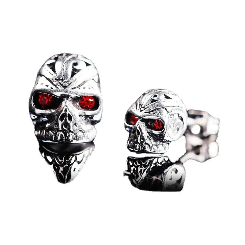 Skull stud earrings with red eye detailing on alloy base with gemstone inlay