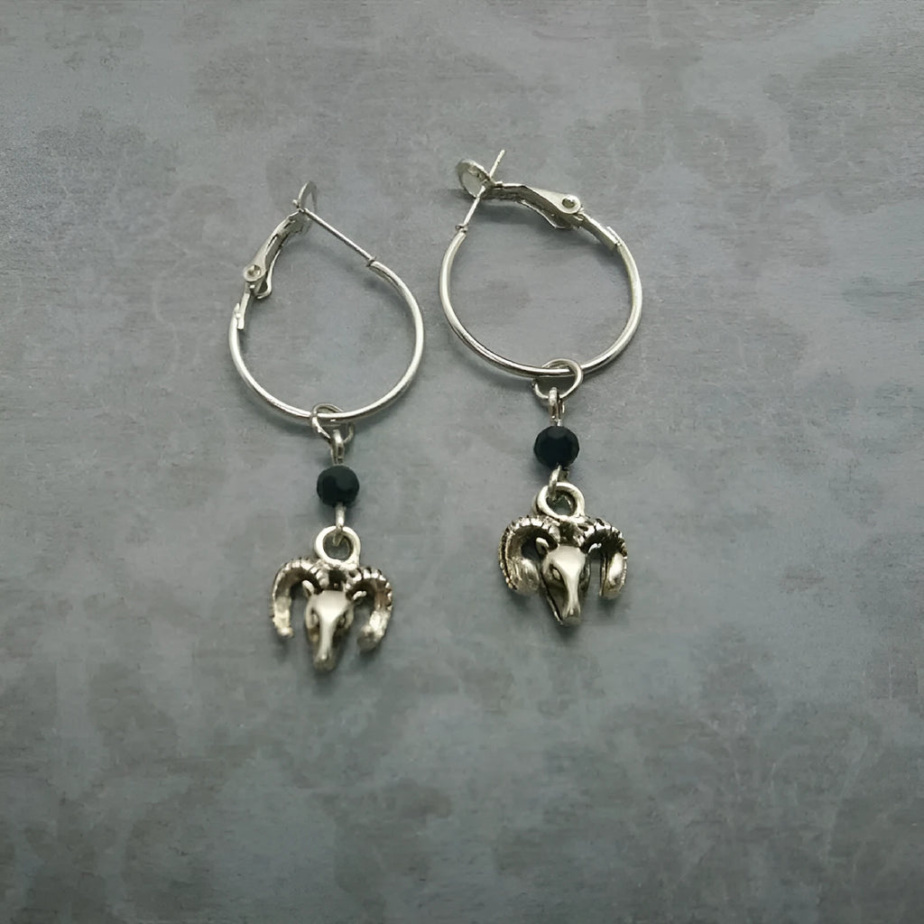 Silver round ring earrings with a Tibetan Antelope design motif.