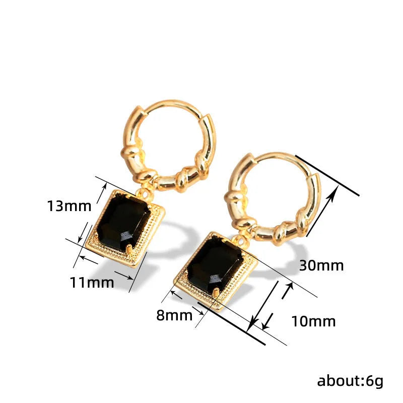 Close-up of black geometric cubic zirconia earrings with a quadrilateral design and butterfly clutch backs.