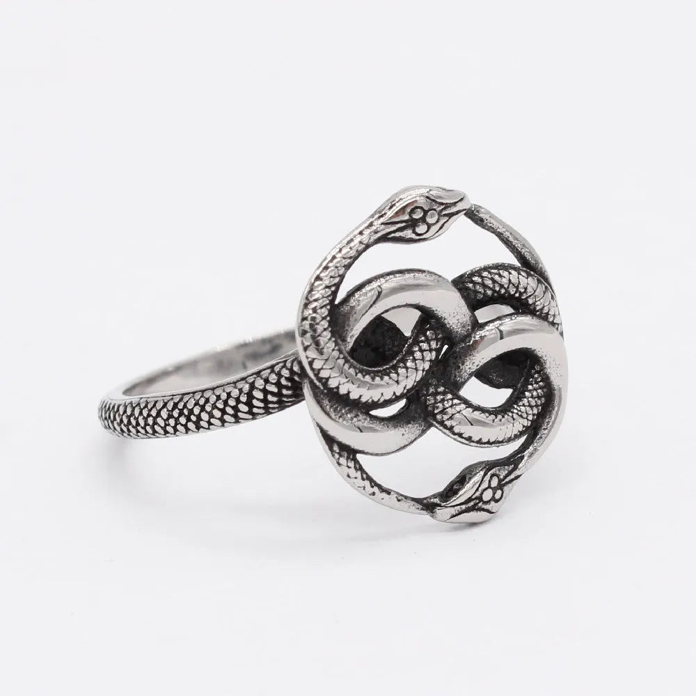 Close-up of a retro-style titanium steel double snake ring in a steel colour on a hand.