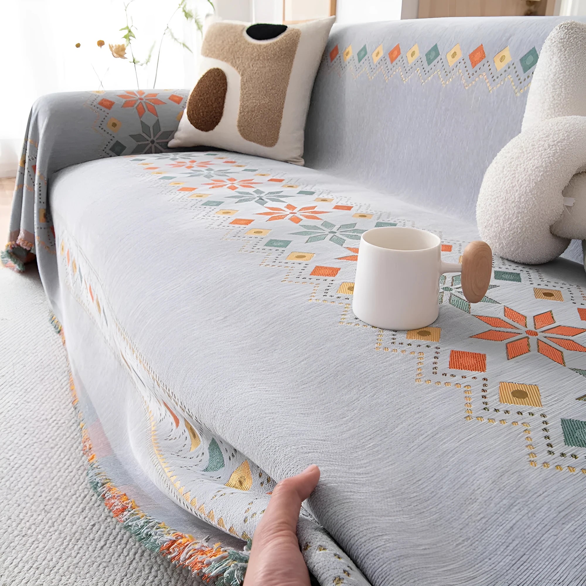 Universal chenille sofa cover in beige with Nordic west blanket pattern on a modern sofa