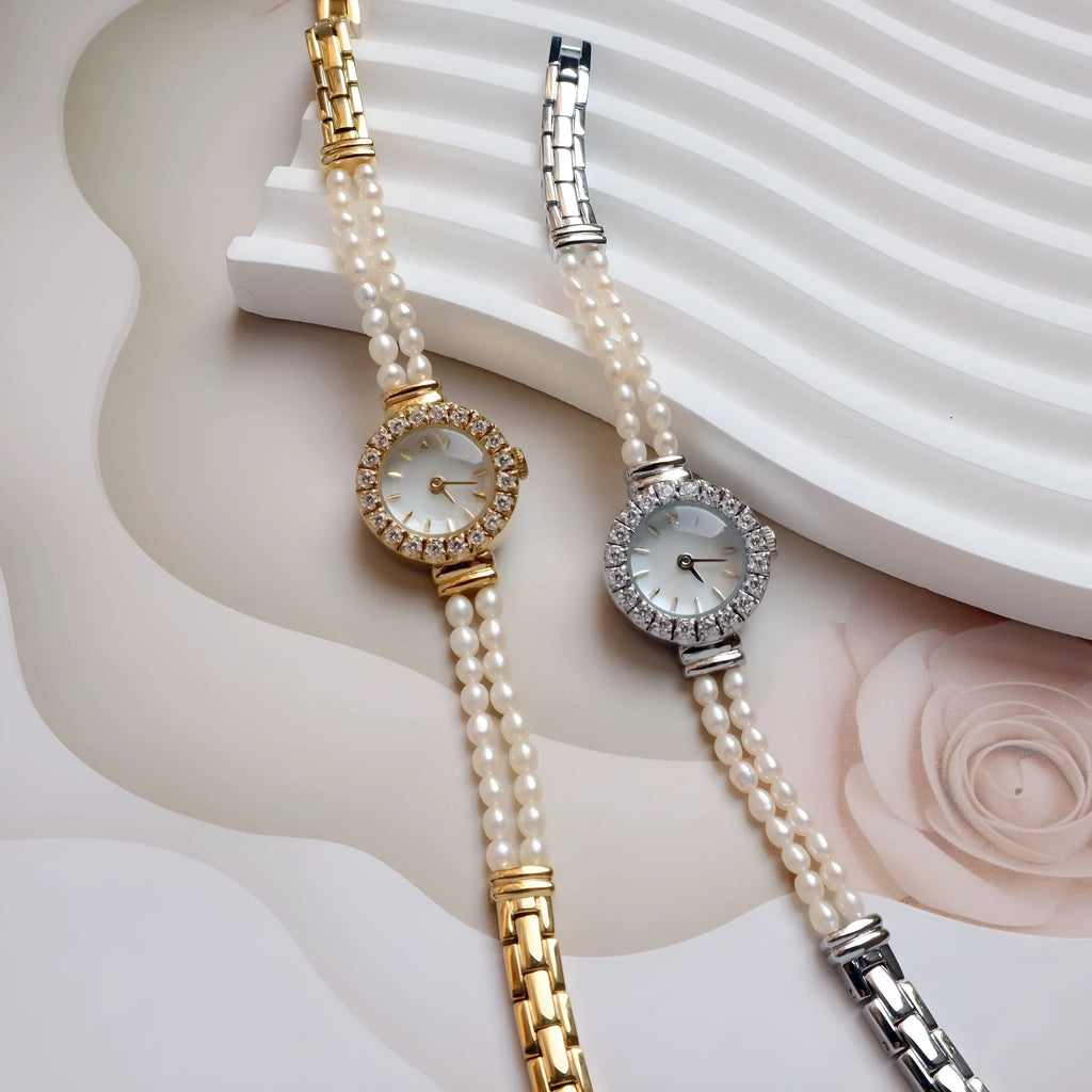 Women's light gold bracelet watch with freshwater pearls, showing 18mm round dial and stainless steel strap.