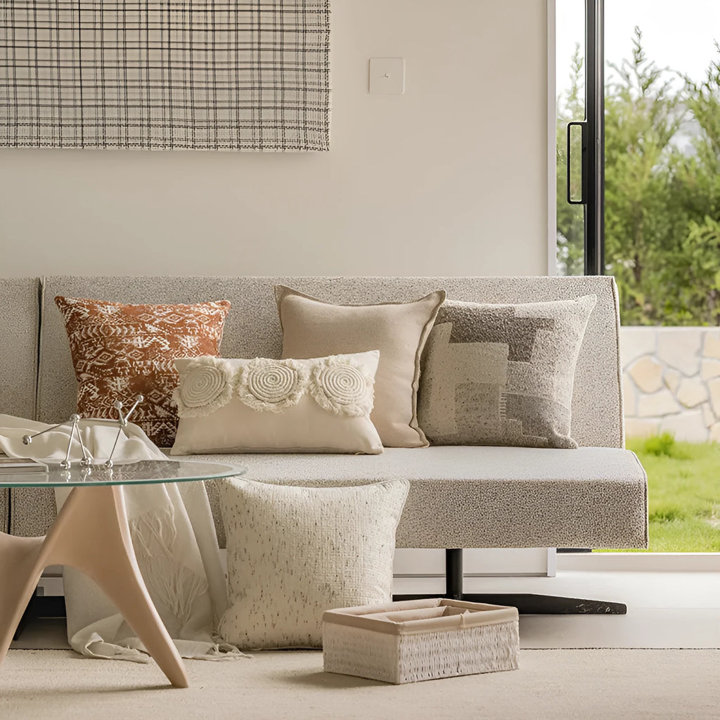 A square pp cotton pillow cushion with a solid red-brown abstract print cover on a sofa.