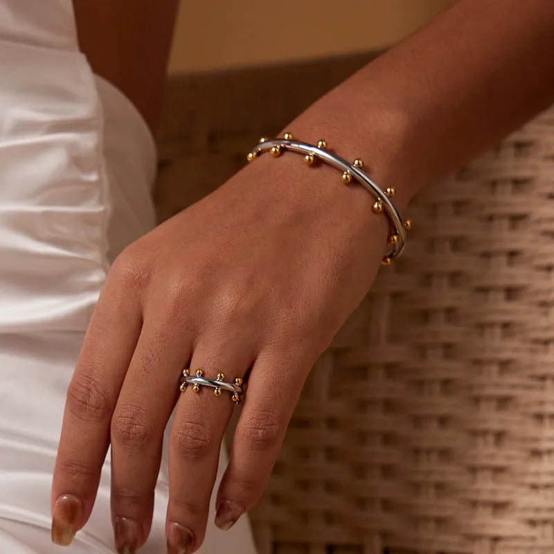 Stainless steel C-shaped bracelet with rivet-shaped bean beads in gold tone