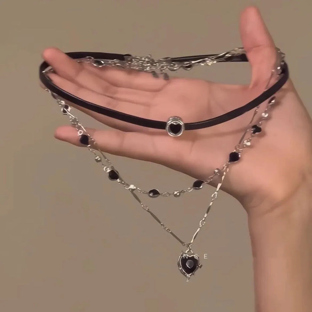 Women's creative multi-layer twin necklace set with alloy heart pendant, artificial crystal, and leather on an adjustable chain.