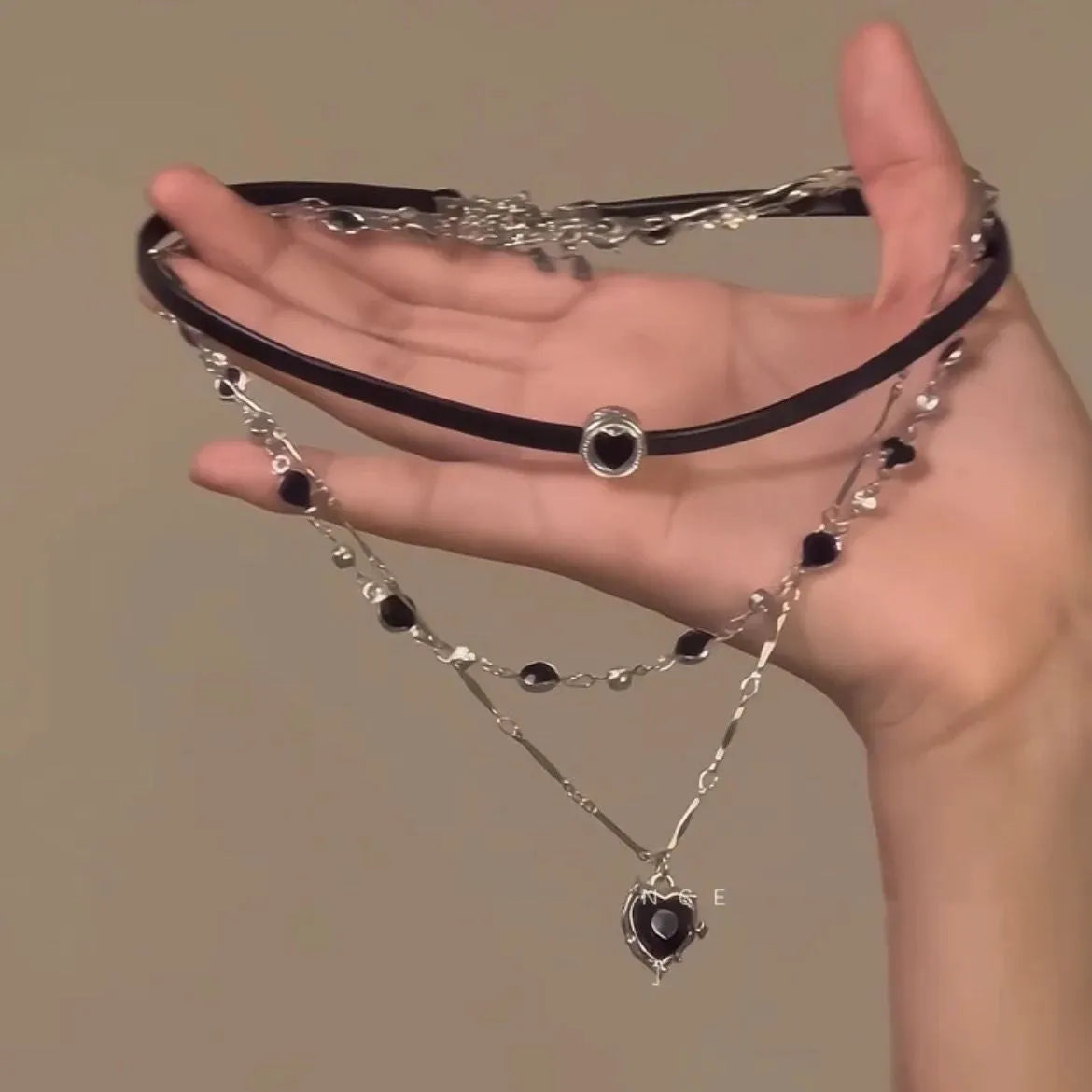Women's creative multi-layer twin necklace set with alloy heart pendant, artificial crystal, and leather on an adjustable chain.