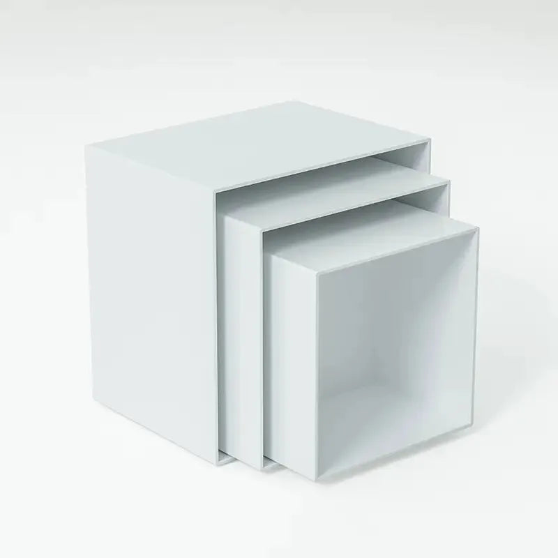 White plastic stacking cube dessert display stand set arranged in a pyramid for cakes and cupcakes.