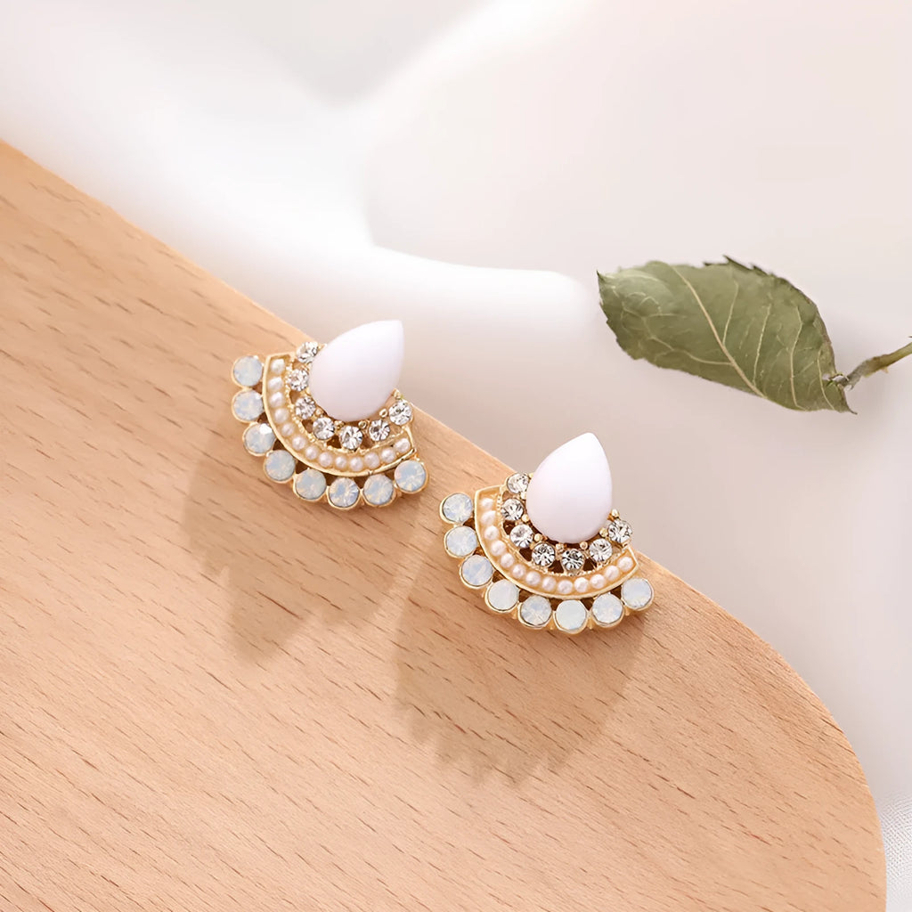 A pair of silver retro fan-shaped stud earrings with rhinestone details on a geometric design.