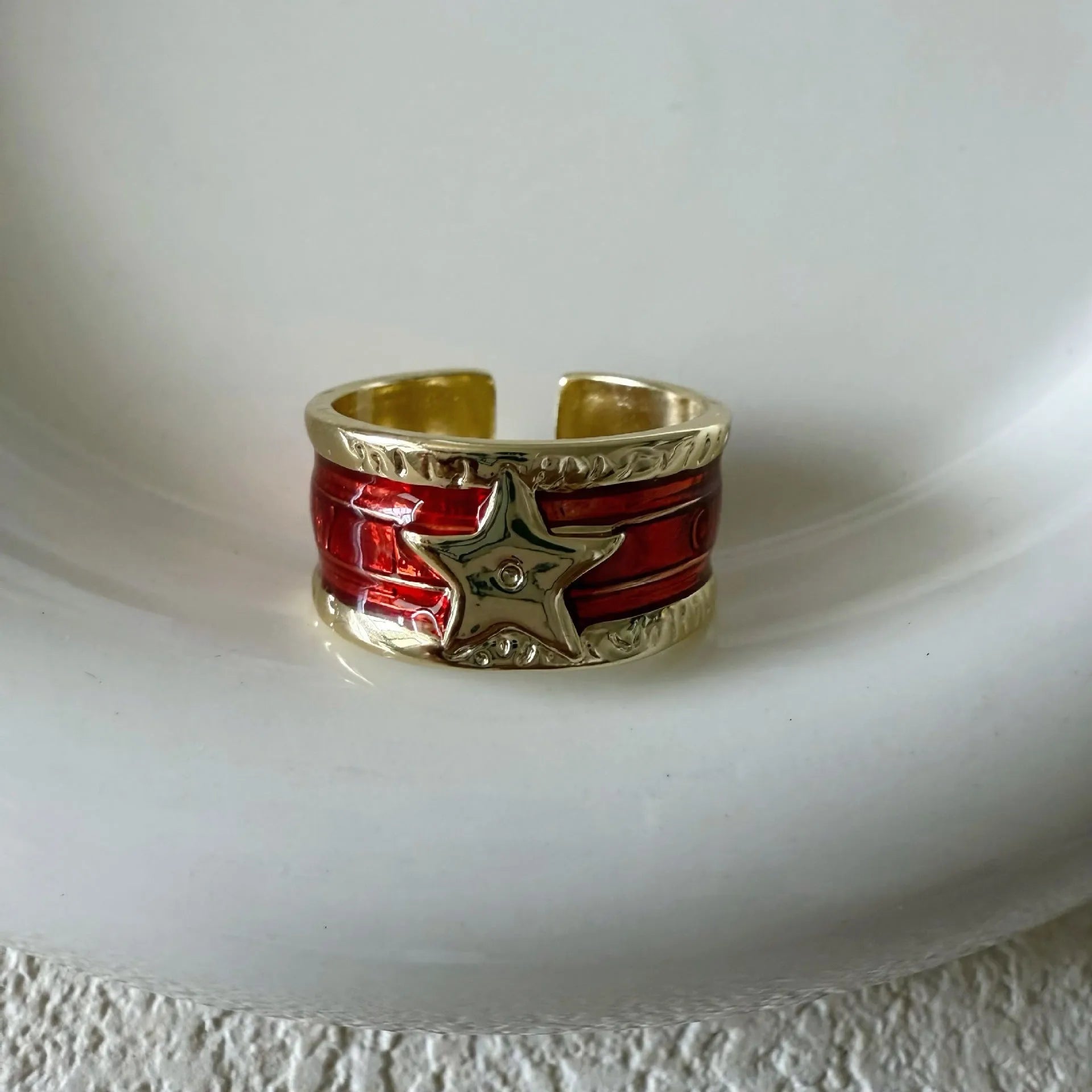 Geometric adjustable copper ring with a distressed XINGX drop oil pattern in multiple colour options.