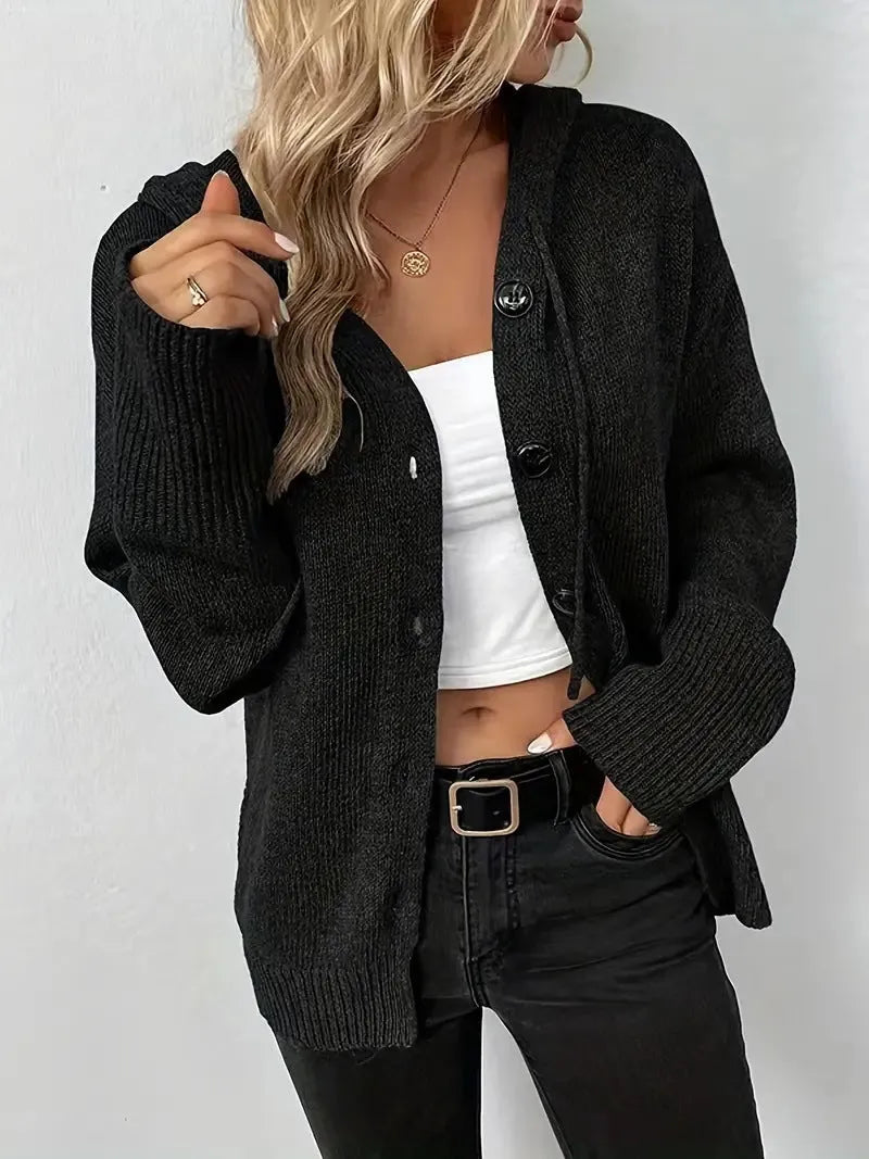 Man wearing a thick grey hooded cotton cardigan sweater with a loose fit.