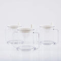 Transparent plastic drinking cup with spill-proof lid on a plain background.