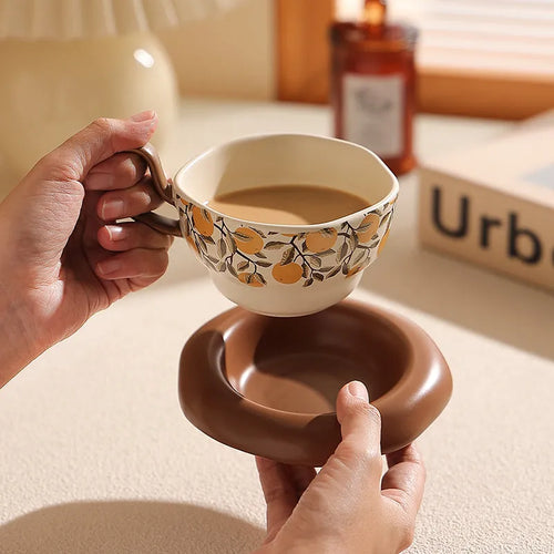 Antique style ceramic coffee cup and saucer set in retro black or orange colour.