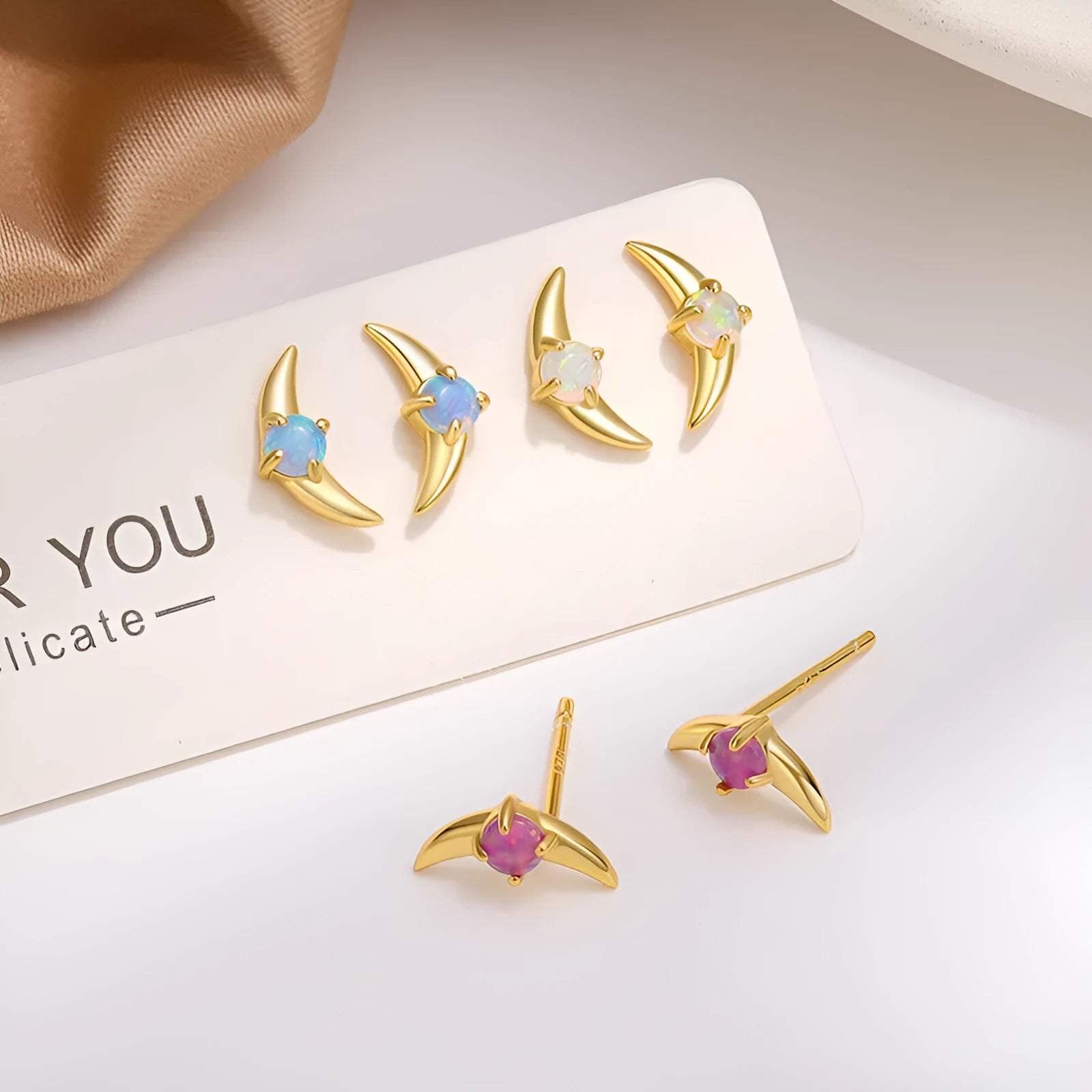 Geometric 925 silver women's earrings with a stone accent, shown in gold and platinum colour options.