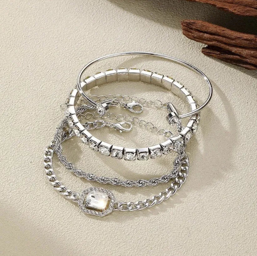 Retro geometric alloy bracelet four-piece set with square diamond details in gold and silver colours.