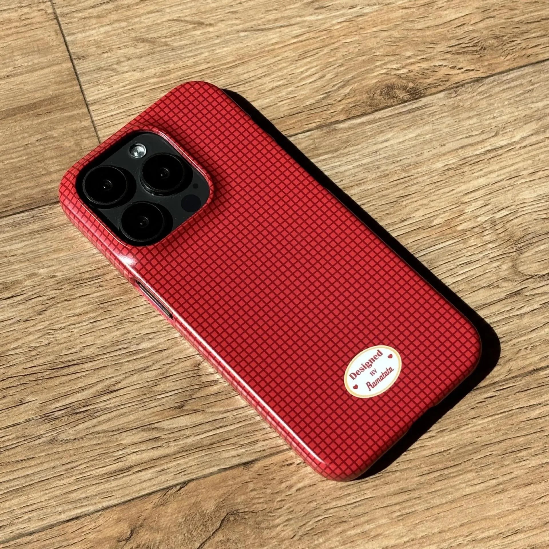 Original plain plaid design iPhone 15 Pro Max case in glossy red grid or frosted orange grid options.