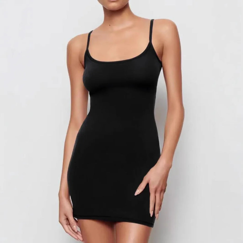A black sleeveless sling dress with a skinny sheath fit and short skirt.