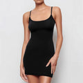 A black sleeveless sling dress with a skinny sheath fit and short skirt.