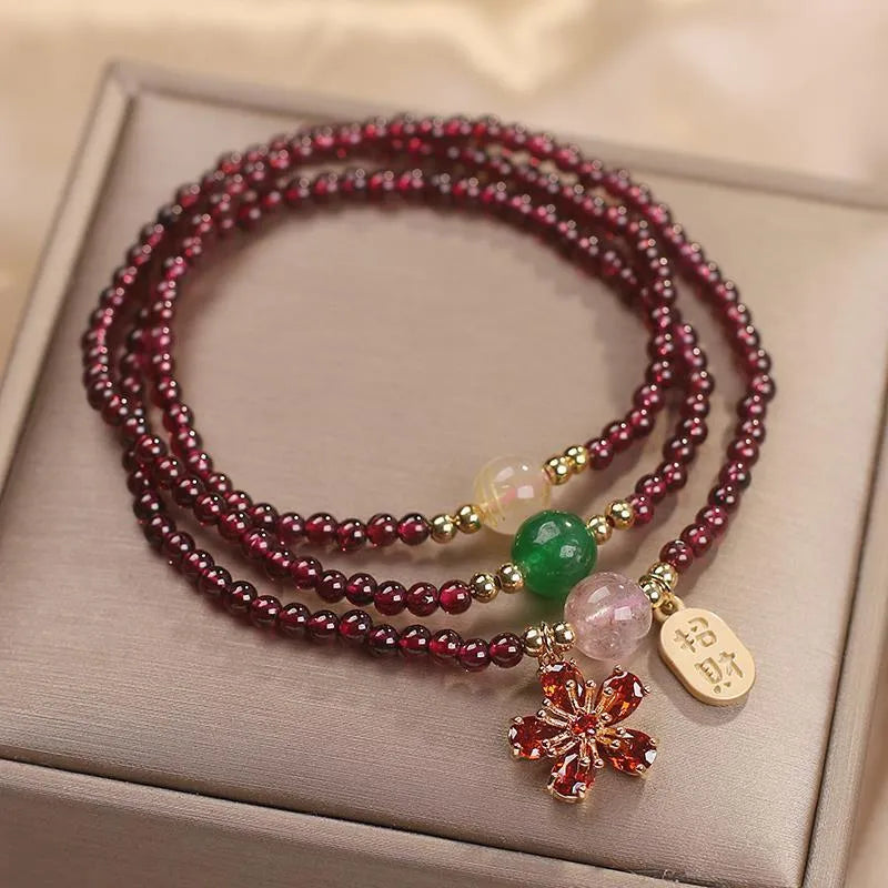 Women's natural crystal bracelet in pomegranate red cherry blossom colour with sequin accents