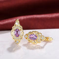 Gold copper flower earrings with hollow design and zircon stones on white background
