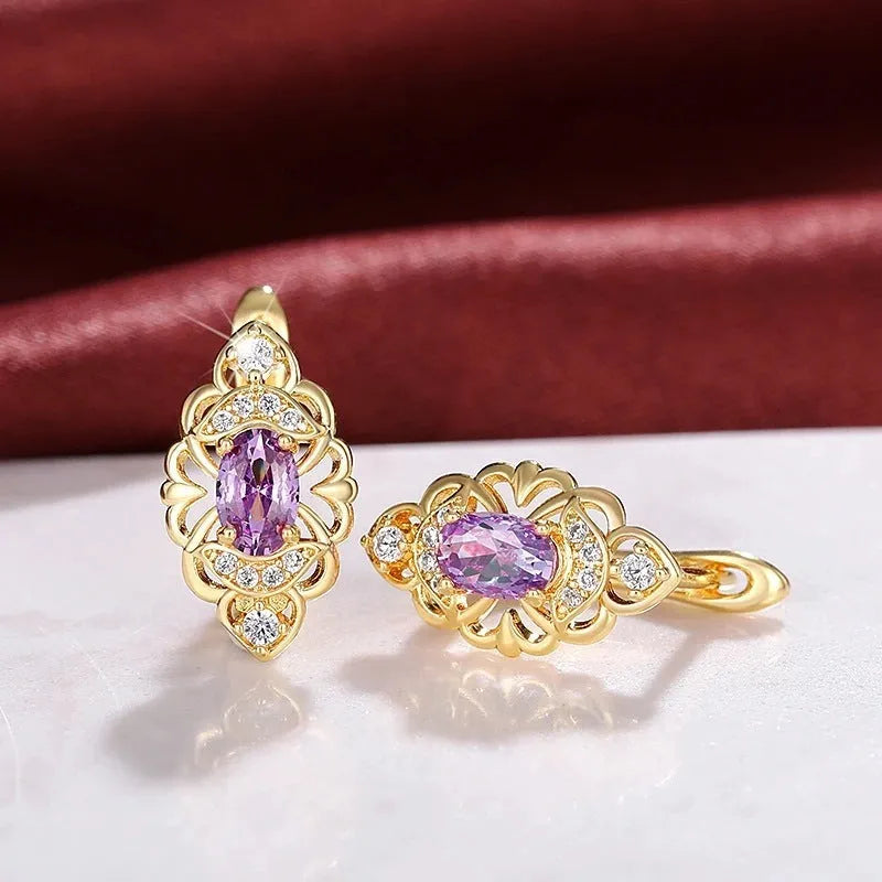 Gold copper flower earrings with hollow design and zircon stones on white background