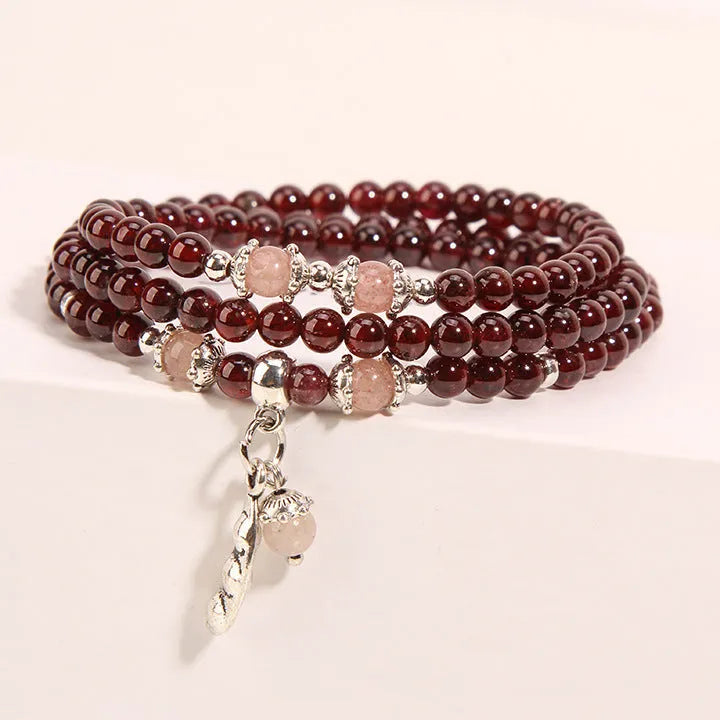 Women's crystal bracelet with wine red garnet colour and flower shape, featuring Bohemian and ethnic design elements.