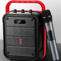 MS62AI black portable Bluetooth speaker with wireless microphone and remote control on a table.
