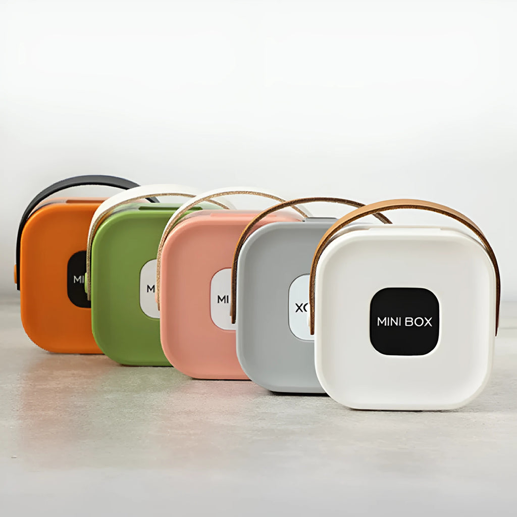 Medium-sized solid colour portable storage box for organising data cables and a Bluetooth headset.