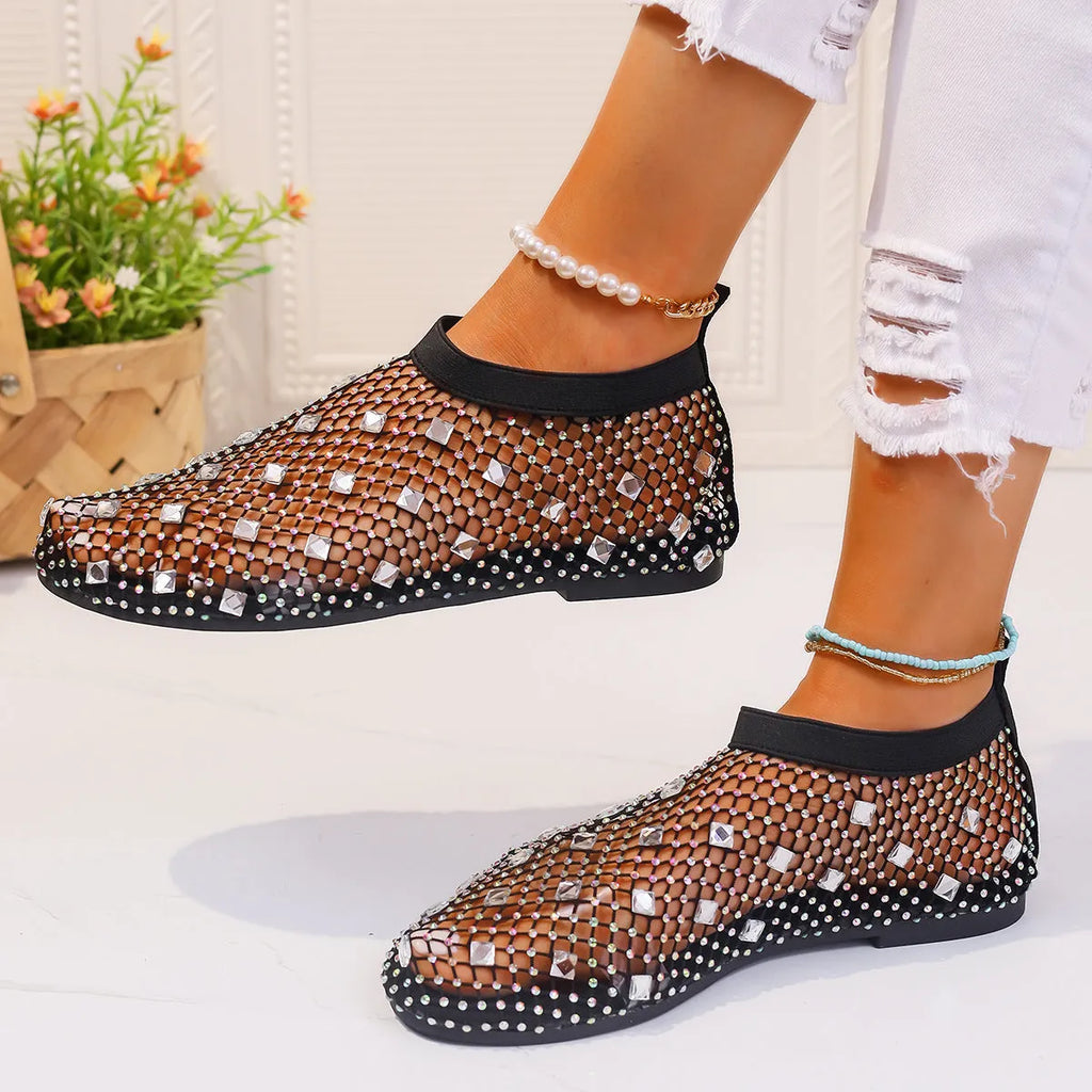 Women's colourful rhinestone flat sandals with mesh upper and rubber sole.