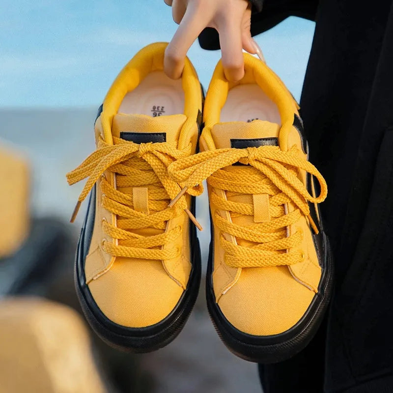Women's blue and white low-top board shoes with vulcanised rubber soles and lace-up front.