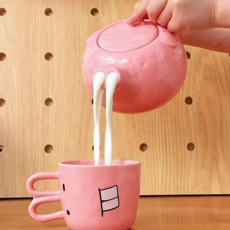 Creative ceramic piggy teapot nose mug set with pink pig pot and rabbit cup on a table