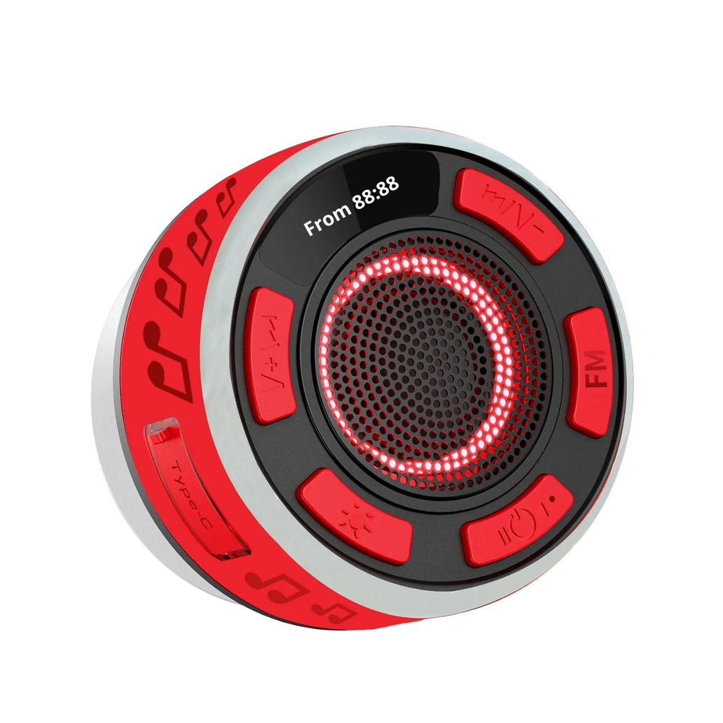 Waterproof Bluetooth speaker with large suction cup in black, mounted on bathroom tile