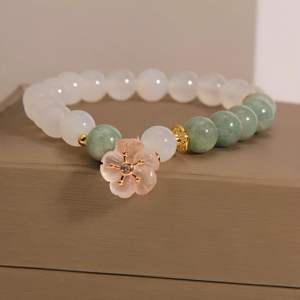 White agate floral bracelet with jade details and adjustable clasp on woman's wrist