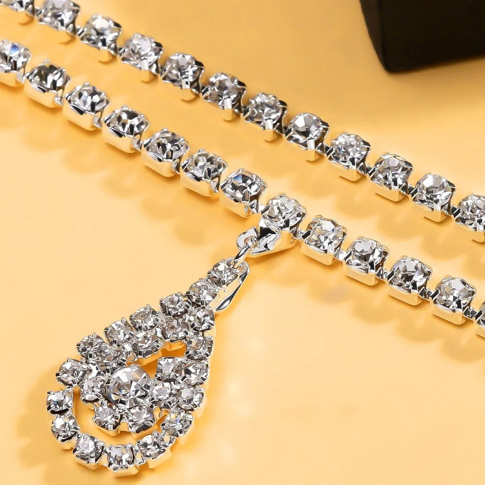 Gold or silver rhinestone waist chain with a water drop pendant and tassel detail