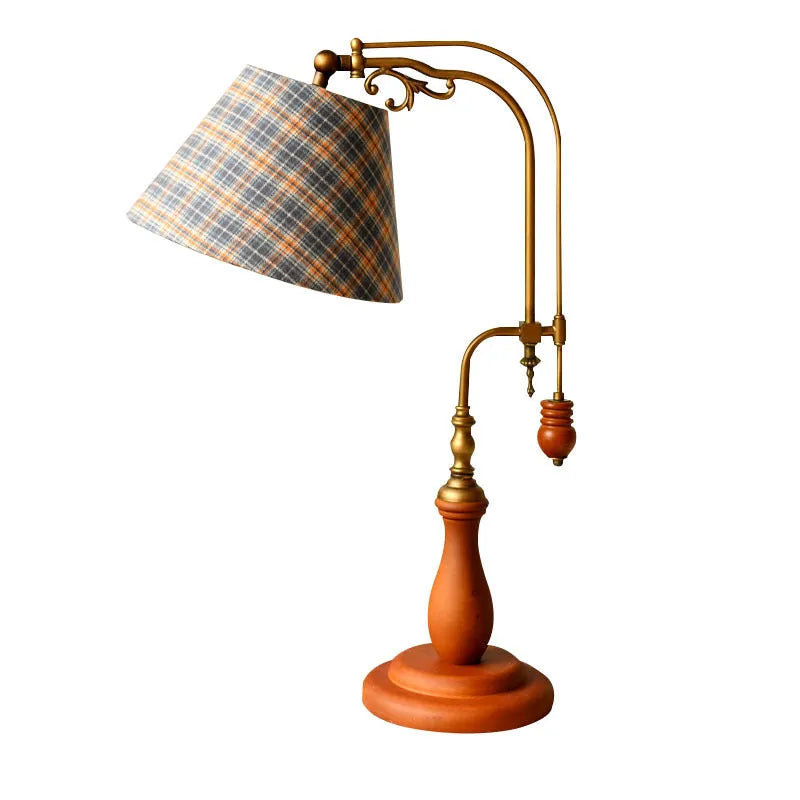Beige fabric shade wooden bedside table lamp on a wooden surface
