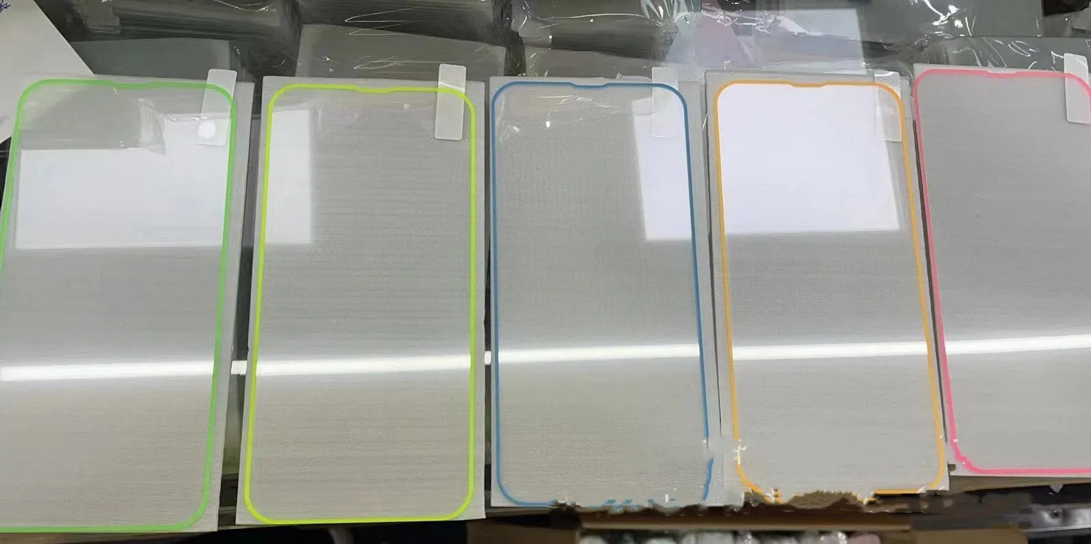 Glow-in-the-dark pink tempered glass screen protector fitted on an iPhone 13 Pro Max showing full-screen coverage.