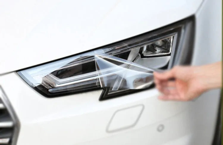 A roll of 30cm wide dark grey car lamp protective film for headlight and taillight protection.