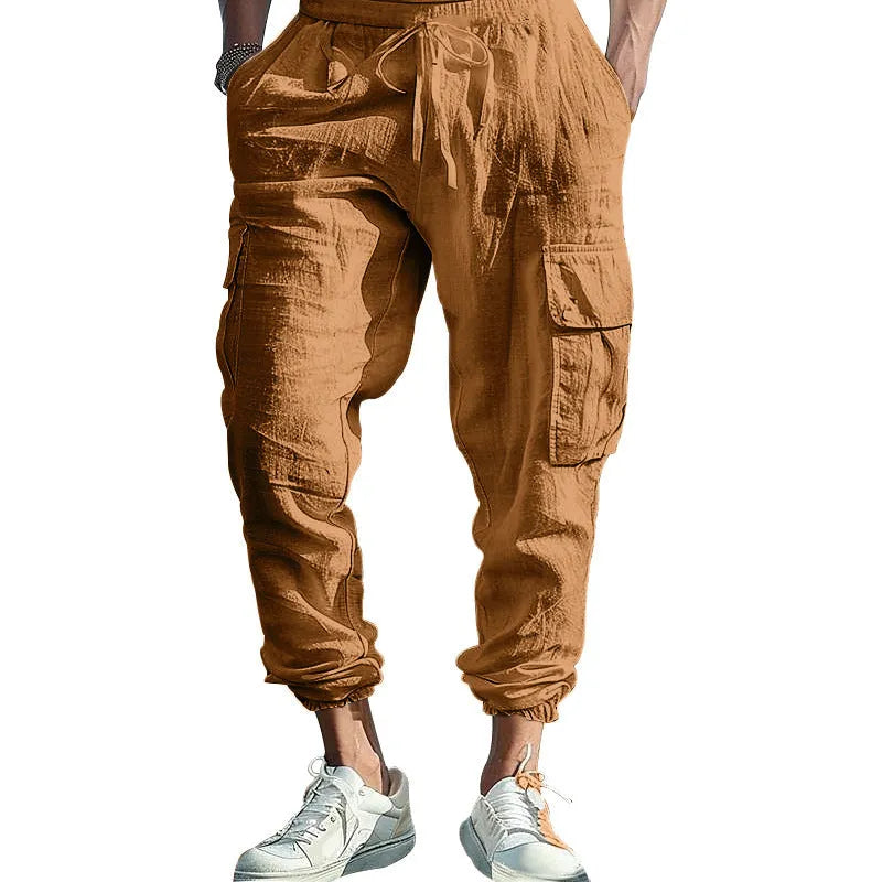 Men's loose-fit linen trousers with ankle ties and a drawstring waist in a solid colour.