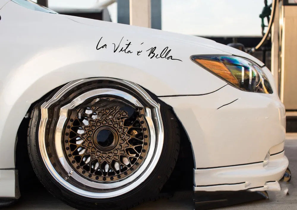 La E Bella reflective car sticker in black, 40x8cm, placed on a car door panel