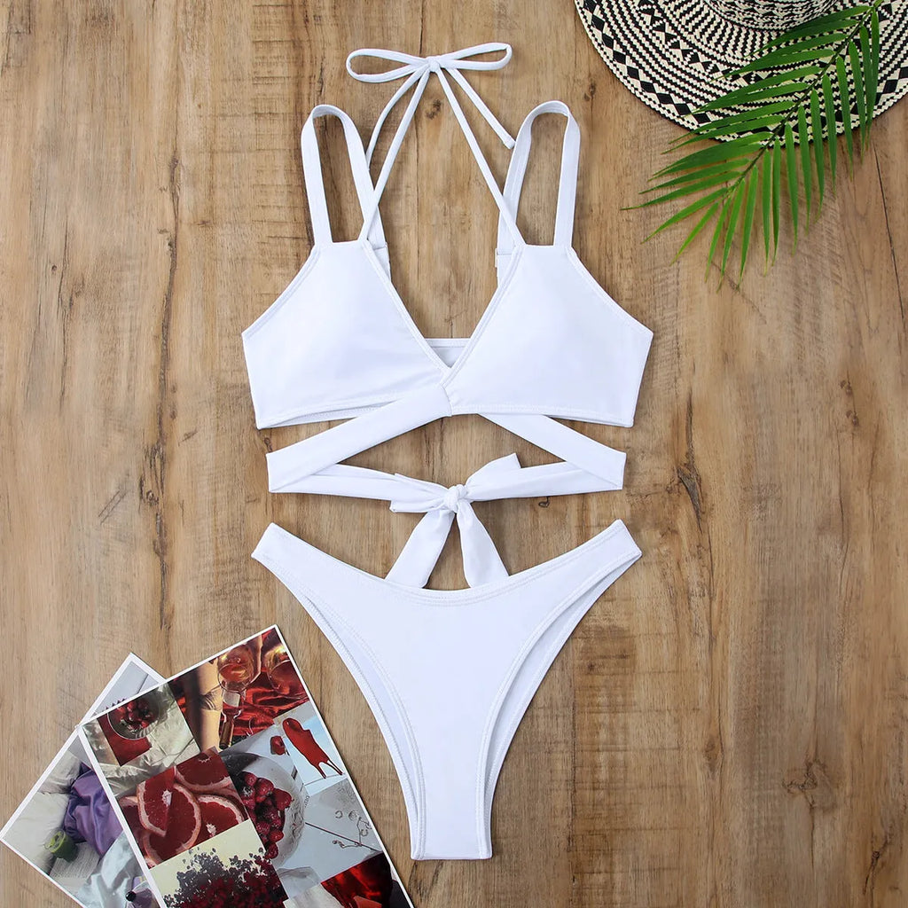 Women's solid colour strappy bikini swimsuit on a hanger, showing the briefs style and strap design.