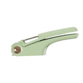 White manual garlic press made of ABS plastic and stainless steel on a kitchen counter.