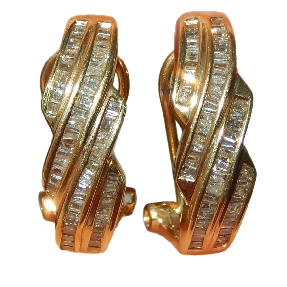 A pair of gold-coloured geometric copper earrings with a round design on a white background.