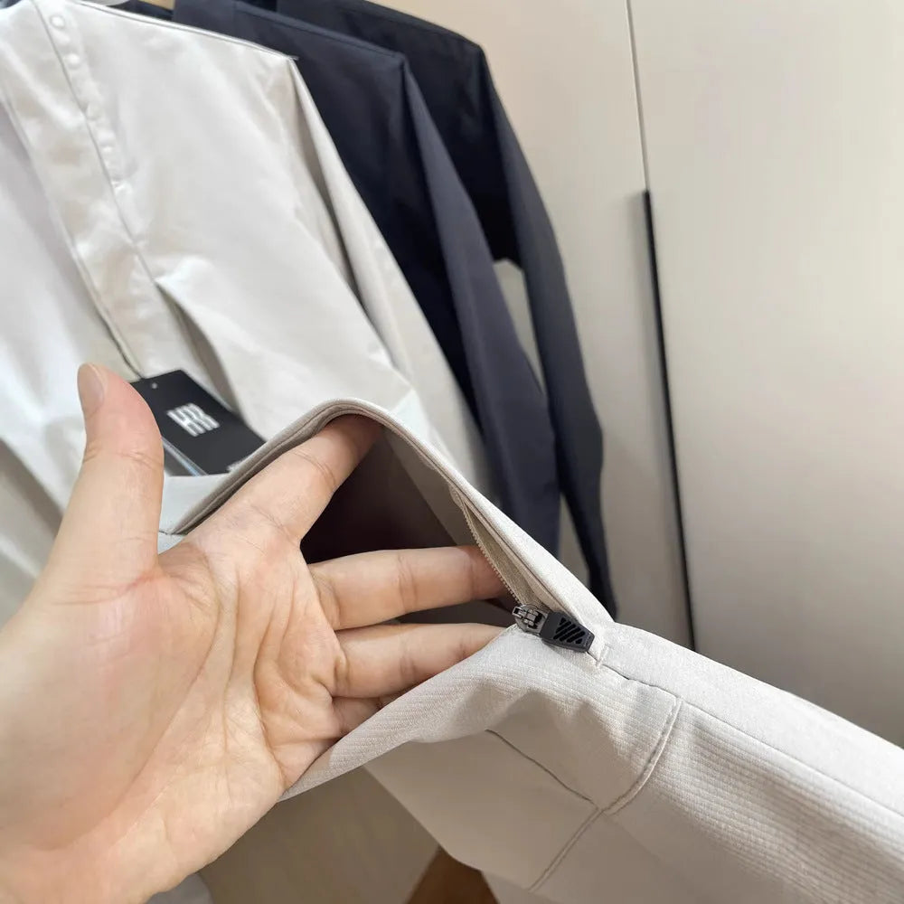 Man wearing a milky white stand collar casual jacket with long sleeves and a straight hem.