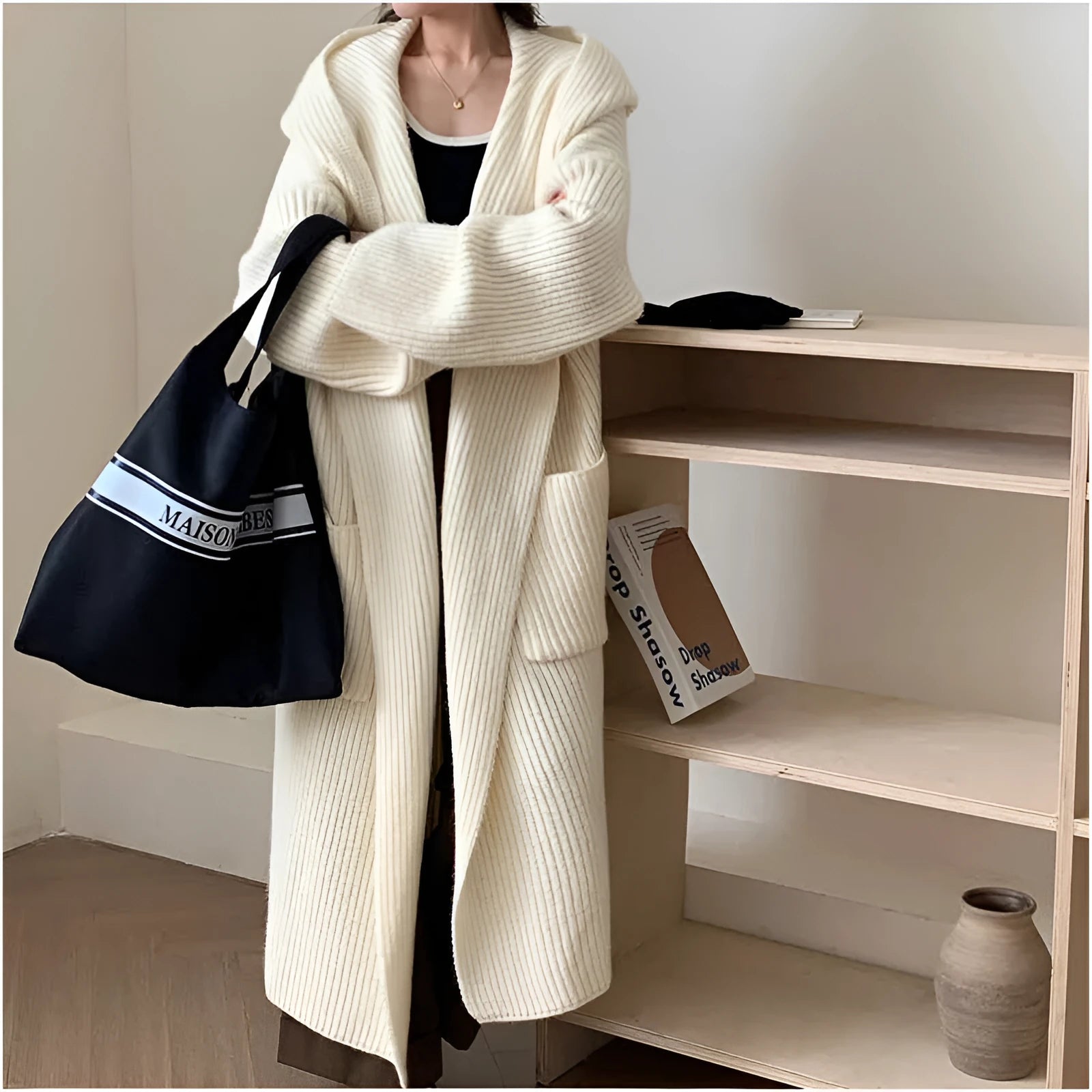 Loose grey hooded cardigan coat for women with raglan sleeves on a hanger